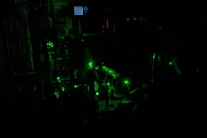 Green lasers on an optical table. 