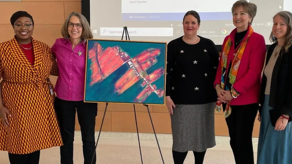 A group of women standing around a painting at the School of Nursing to talk about art in the crisis. 