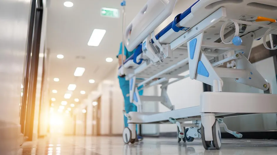 A gurney wheels through a hospital