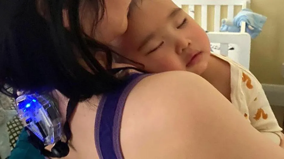 A mother using a new Columbia-created device called Joey to monitor her parenting practices with her baby.
