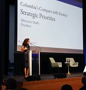 Columbia President Minouche Shafik at podium addressing Operations staff