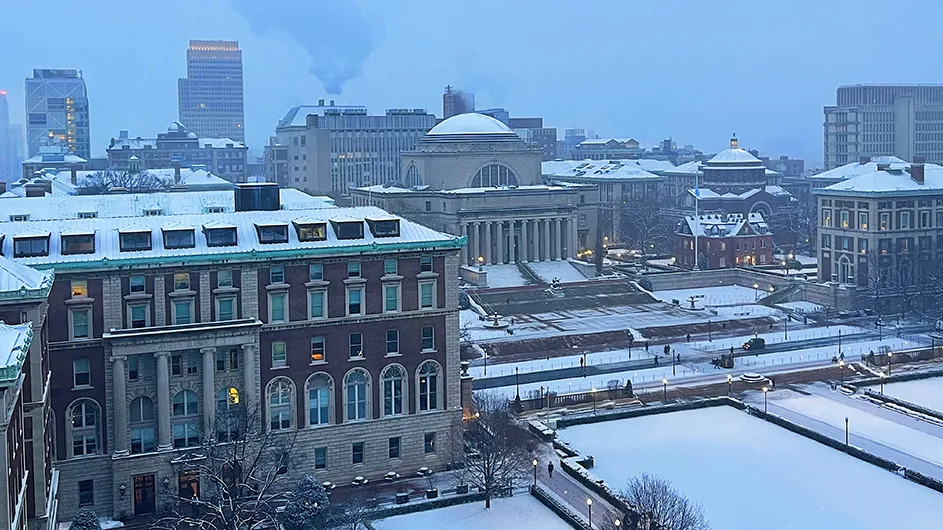 Morningside campus showing Low Library, South Lawn, Pulitzer Hall, and other buildings blanketed in snow at Columbia University. 