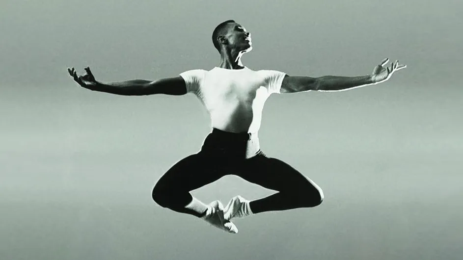 Ballet dance pioneer Arthur Mitchell leaps across the stage in a 1985 Dance Theatre of Harlem production.