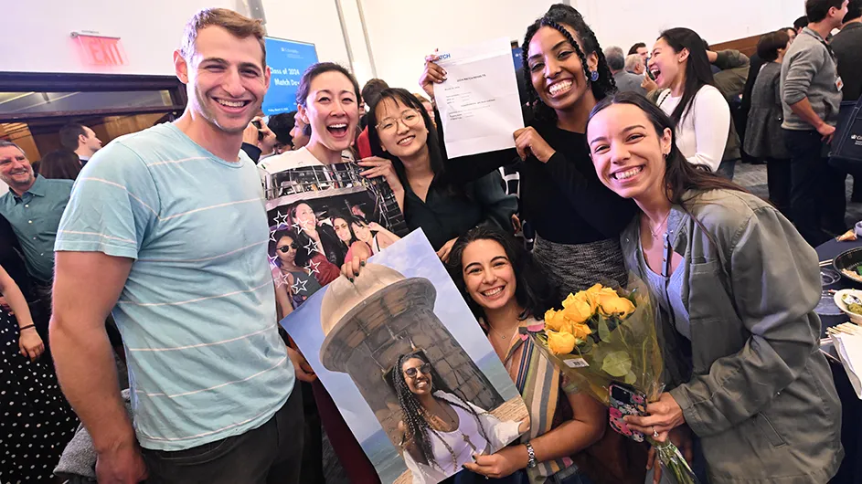 Six students celebrate and pose with letters and photos during Columbia's Vagelos & Physicians annual Match Day for residencies at Columbia Medical Center.