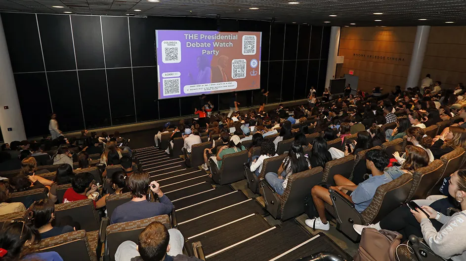 Hundreds of students sit in Lerner Roone Arledge Cinema ready to watch the Kamala Harris & Donald Trump presidential debate on a big screen at Columbia University. 