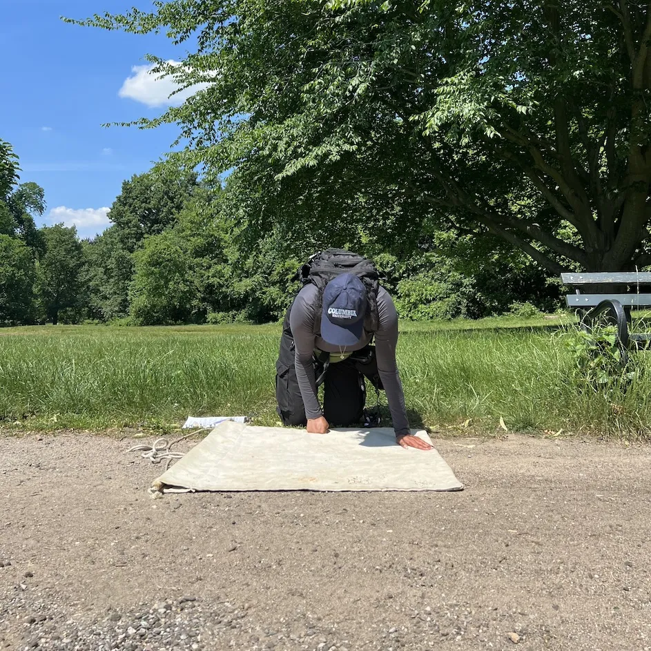Apoorva Sakthivel, a research assistant on the survey, inspects a corduroy cloth for ticks. (Christopher D. Shea)