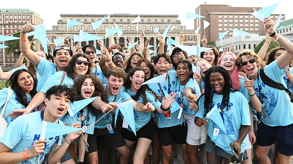 NSOP leaders wave light blue pennants as new students arrive on campus. 
