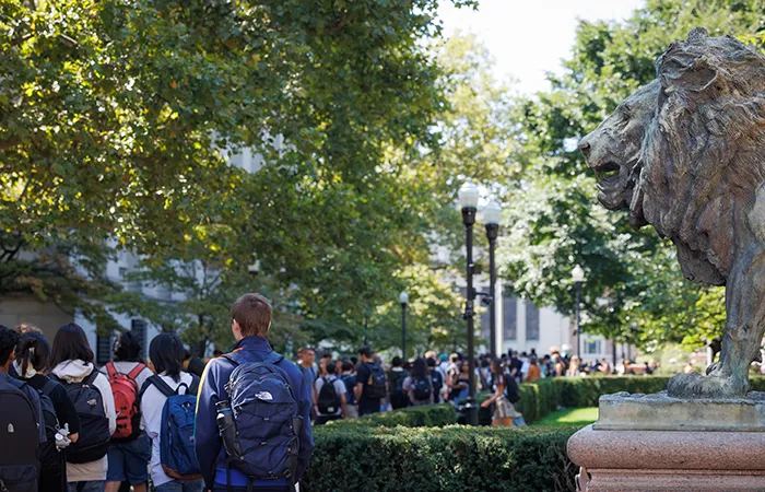 Students walk past Scholars Lion on the first day of classes. 