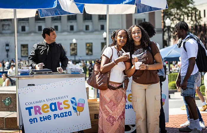 Two students pose at Treats on the Plaza on Morningside campus. 