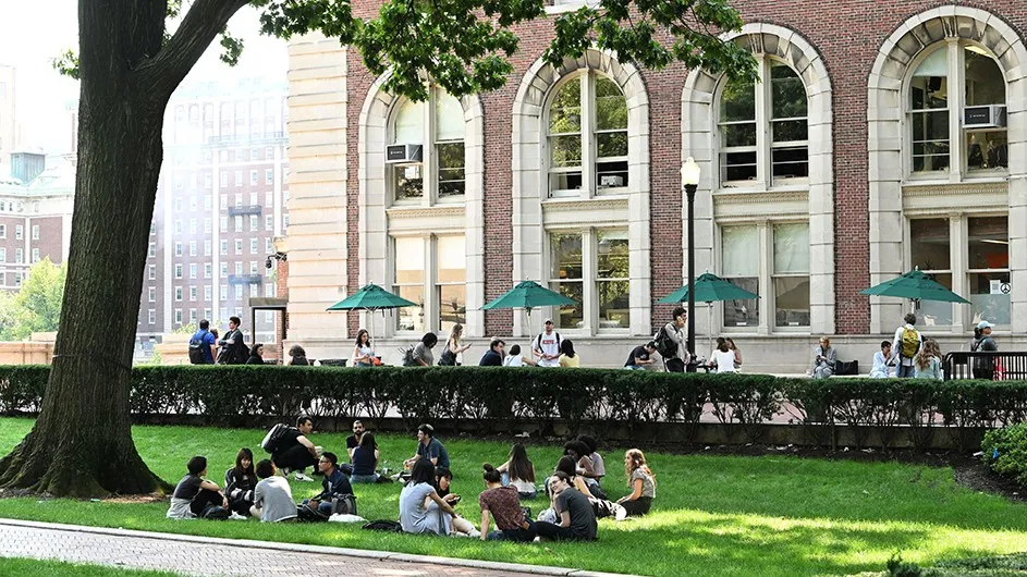 Students sit on the lawn