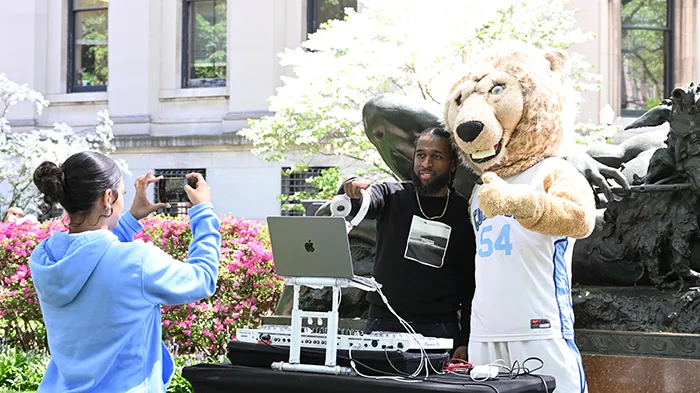 DJ poses for a photo with Roar-ee