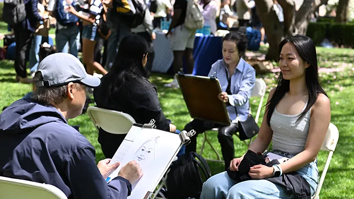 A student sits for a drawing.