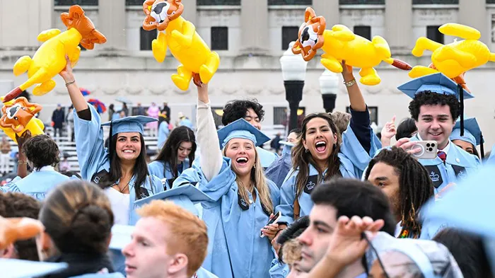 Columbia College grads wave inflatable lions at Commencement. 