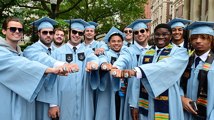 A group of Columbia grads show off their Columbia "C" rings. 