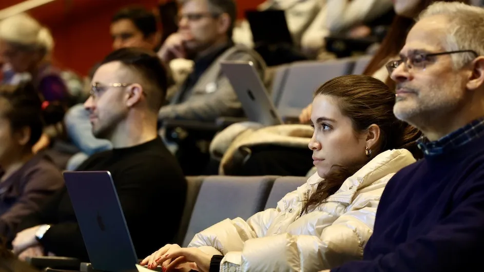 Audience members listen to a speaker at a Columbia AI Summit session on the medical campus.