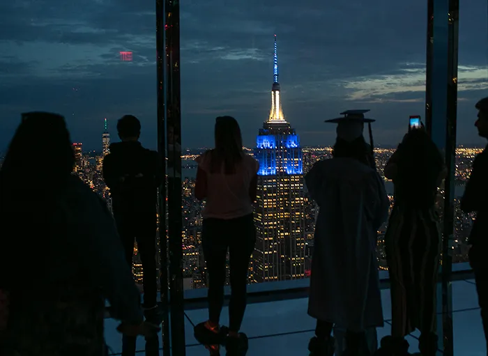 The Empire State Building lit in blue as viewed from Summit One Vanderbilt.