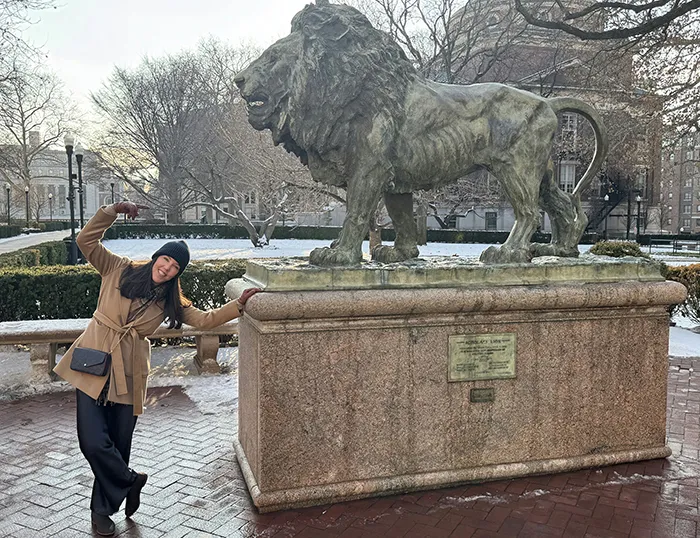 Corina Stone poses with scholars Lion