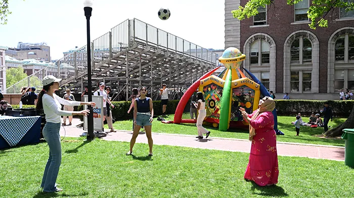 Students toss a soccer ball