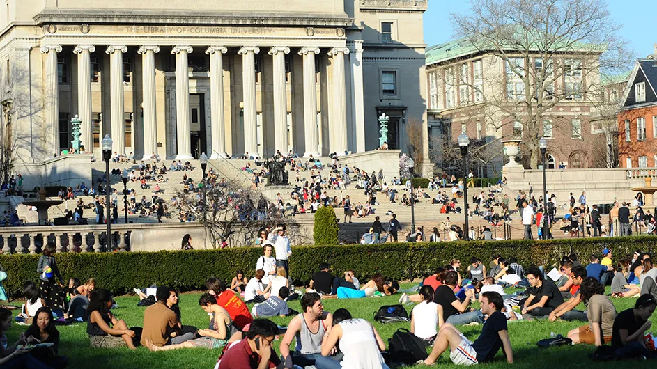 Students sitting on South Lawn and the steps of Low Library