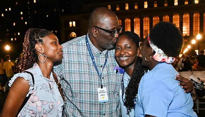 A family says goodbye to their Columbia student after Convocation on Butler Lawn.