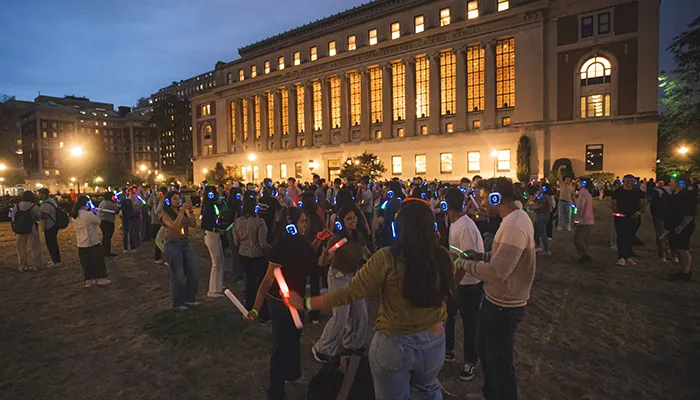 Students dance during a silent disco on in front of Butler Library.