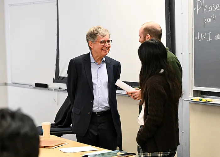 Nobel Memorial Prize in Economic Sciences winner Michael Woodford speaks with his Teaching Assistants.