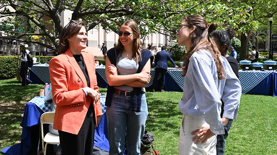 Acting President Claire Shipman chatting with students outside.