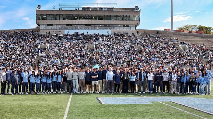 A large crowd gathered at the football stadium.