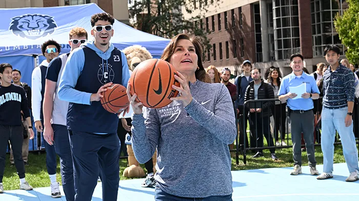A woman about to throw a basketball.