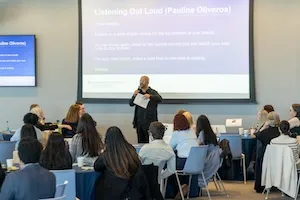 Group of people in a conference room listening to a presentation. 