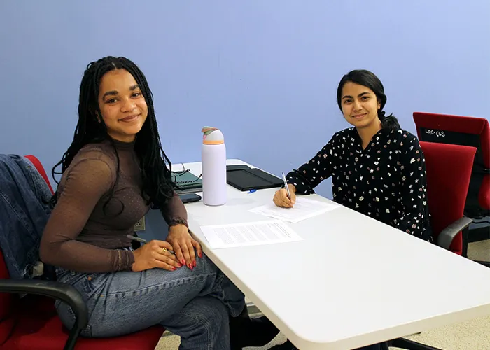 Natasha Kolombo (CC'29) and Rinaz Jamal (CC'29) work on an episode about Alejandre Tentle. Photo by Kelly Moffitt-Hawasly.