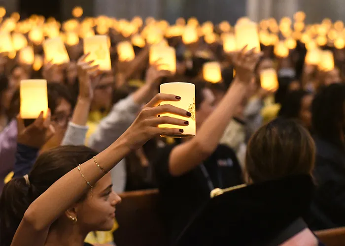 Barnard students raise candles for Convocation.