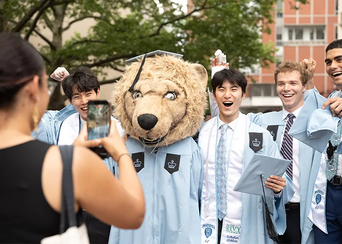 Roar-ee poses with grads.