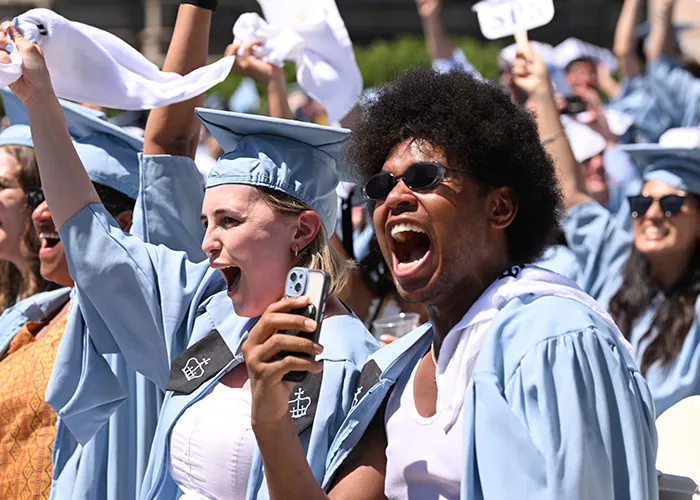 Columbia Business Shool and Columbia School of Professional Studies students cheer on Jon Batiste