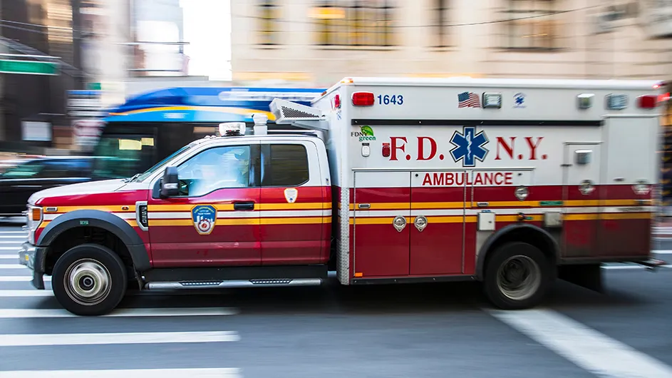 New York Fire Department ambulance rushing by on a city street. 