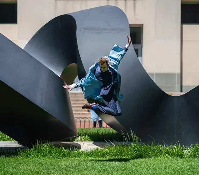 Aidan Hurff (CC’25) jumps in front of the curl