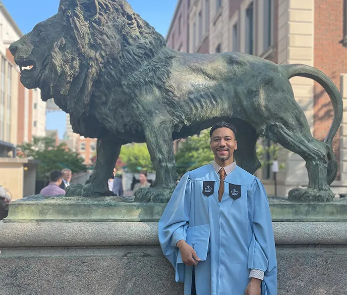 Sean Stokes (TC’24) in front of scholars’ lion