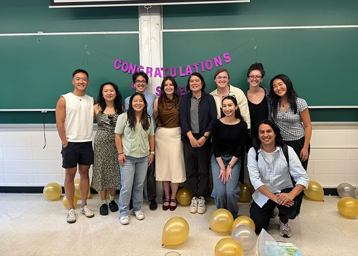 Kristin Myers poses with doctoral students after a successful thesis defense. 