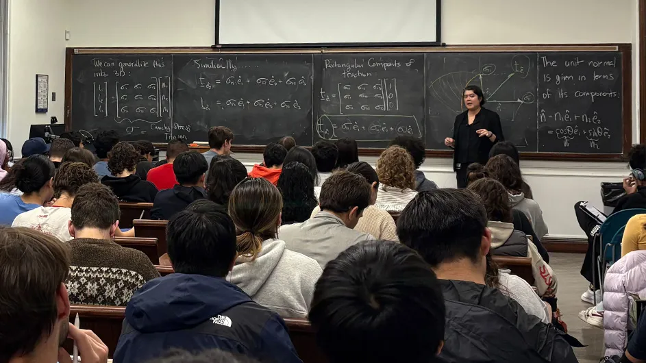 Kristin Myers teaches at a chalkboard. 