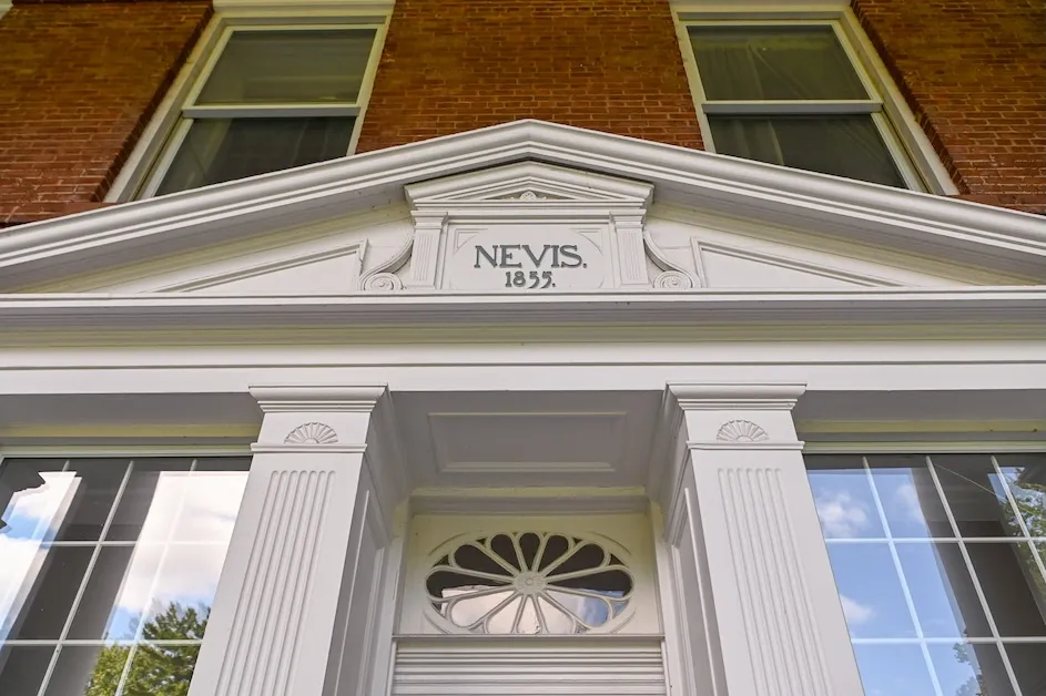 A sign on the original house on the Nevis campus.