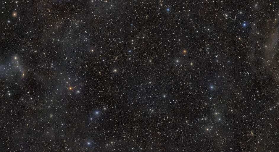 This image from NSF–DOE Vera C. Rubin Observatory reveals the COSMOS field, a clear window into the distant Universe. Combining multiple LSST Camera observations, it captures galaxies and clusters across cosmic time, along with faint wisps of Milky Way dust. (NSF–DOE Rubin Observatory/NOIRLab/SLAC/AURA)