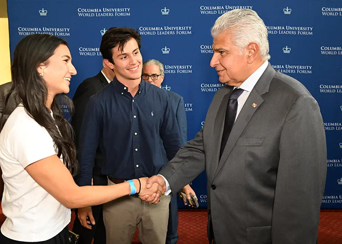 José Raúl Mulino Quintero, President of the Republic of Panama, shaking hands and greeting two university students at the 2026 Columbia University World Leaders Forum.