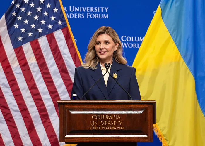 First Lady of Ukraine Olena Zelenska speaks at a podium with American and Ukrainian flags in the background at the 2026 Columbia University World Leaders Forum.