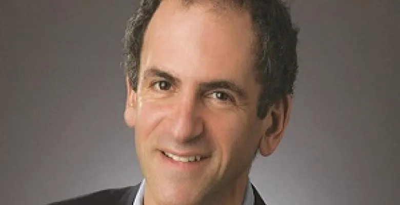 Barron H. Lerner is smiling directly into camera lens with a smile.  Image caught is of Barron's full face with a peep of top shoulder area as he wears a dark blazer.
