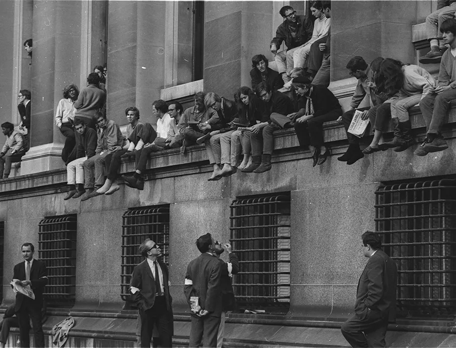 Students sit on the outside of Low Library