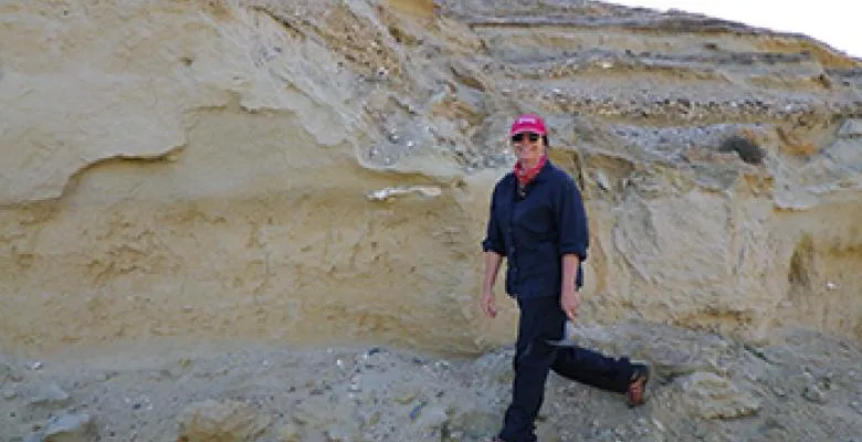 Maureen Raymo standing in front of a wall of rock