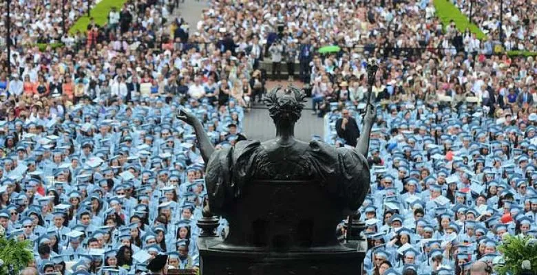 Graduates sitting in blue
