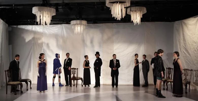 Actors stand on a stage