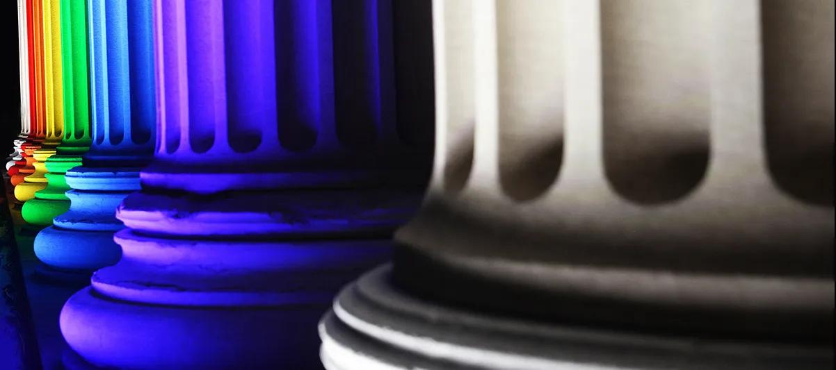 A series of columns each lit up in one color of the rainbow.
