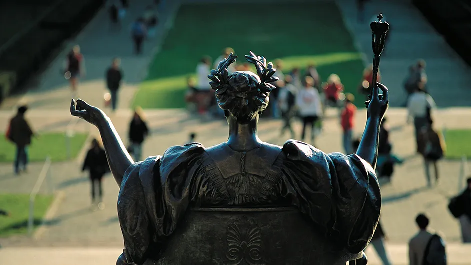 A view of the Alma Mater statue from behind overlooking College Walk.